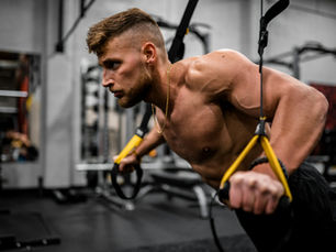 Male athlete using elastic resistance bands during a strength training session