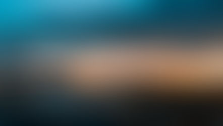 Hong Kong Immigration - Cityscape at sunset with a vibrant orange sky, silhouetted buildings, and twinkling city lights reflecting on water. Calm and serene mood.