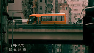 Hong Kong Startup: Orange bus on an elevated road in an urban setting with tall, aged buildings in the background. Visible text in Cantonese in the foreground.