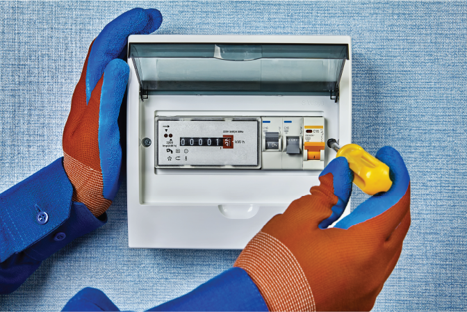 Hands in blue and orange gloves adjust an electrical panel with a screwdriver. Blue textured background, display reads 00001 kWh.
