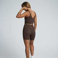 Two-piece women’s workout set featuring compression-fit top and contour-seamed shorts in coffee brown.