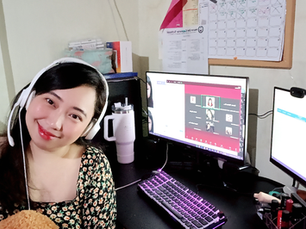 Olivia Pros trainer working at her desk in a professional office environment, smiling while supporting virtual assistant training
