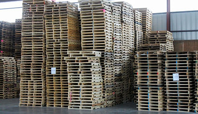 Many stacks of like new, recycled buying pallets