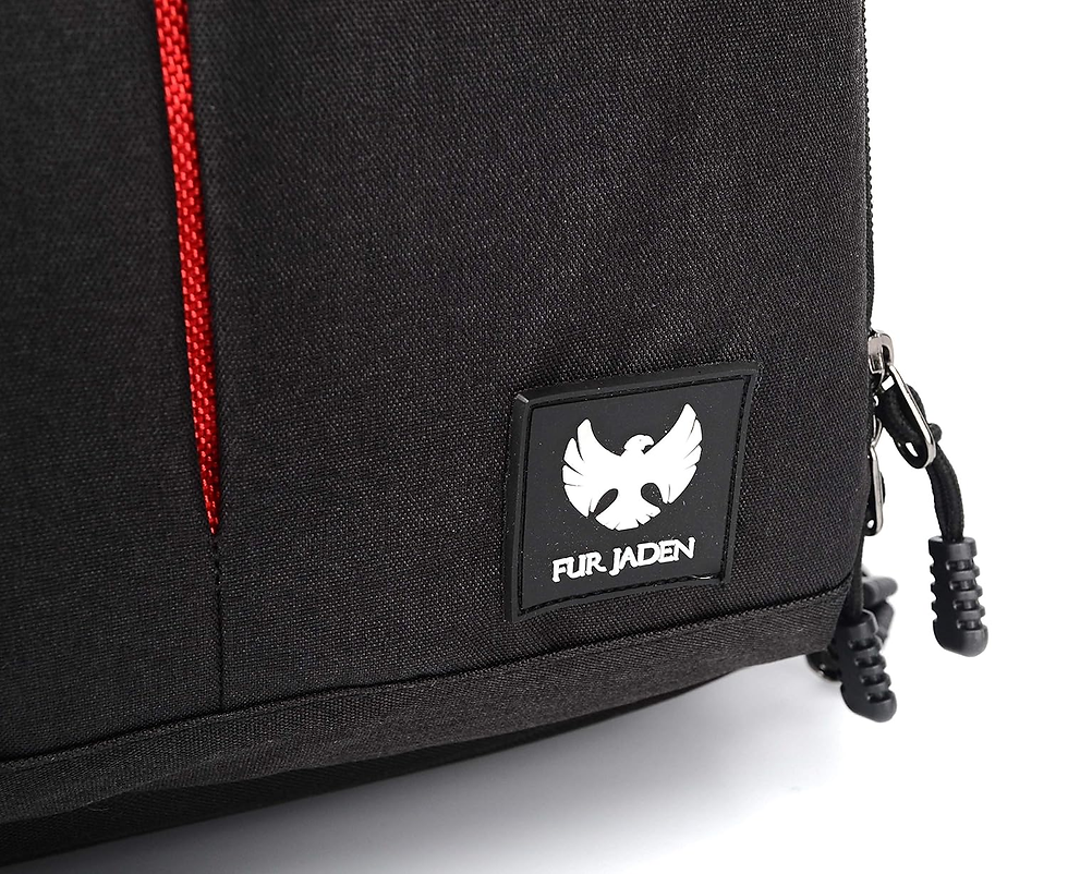 Black backpack with red accents, visible logo of a white bird and text "FUR JADEN." Black zipper pull in bottom right corner.