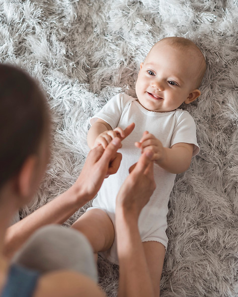 Mom and her baby enjoying play time together, making eye contact and enjoying their time together