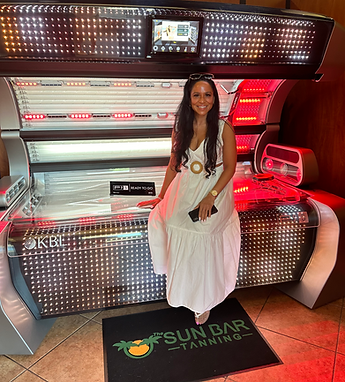 Jamie Normandia, owner of The Sun Bar Tanning in North Andover, featuring red light therapy tanning bed