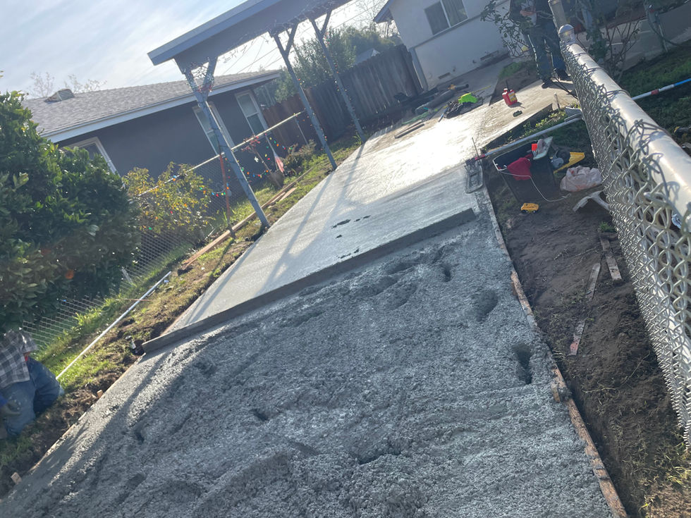 Concrete slab in residential backyard under construction.