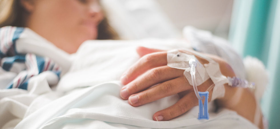 Doctor's hands on table facing cancer patient