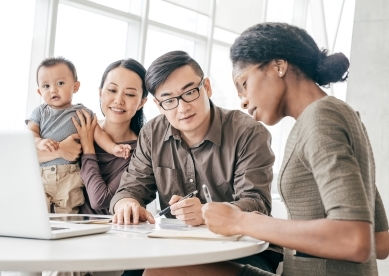 Couple with baby meeting with professional advisor