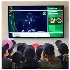 Spy_Co agents listening to instruction from Octagon at the kids' spy party.webp