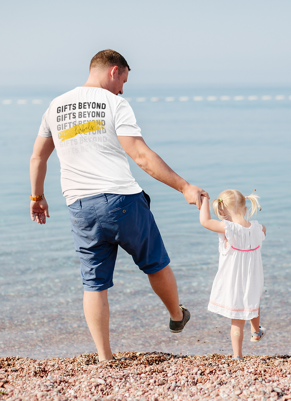 Thumbnail: White Affirmation Tee worn by adult male holding his daughter’s hand