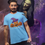 Thumbnail: Man wearing "All Kinds of Different" T-shirt, standing with Halloween-themed background and witch costume.
