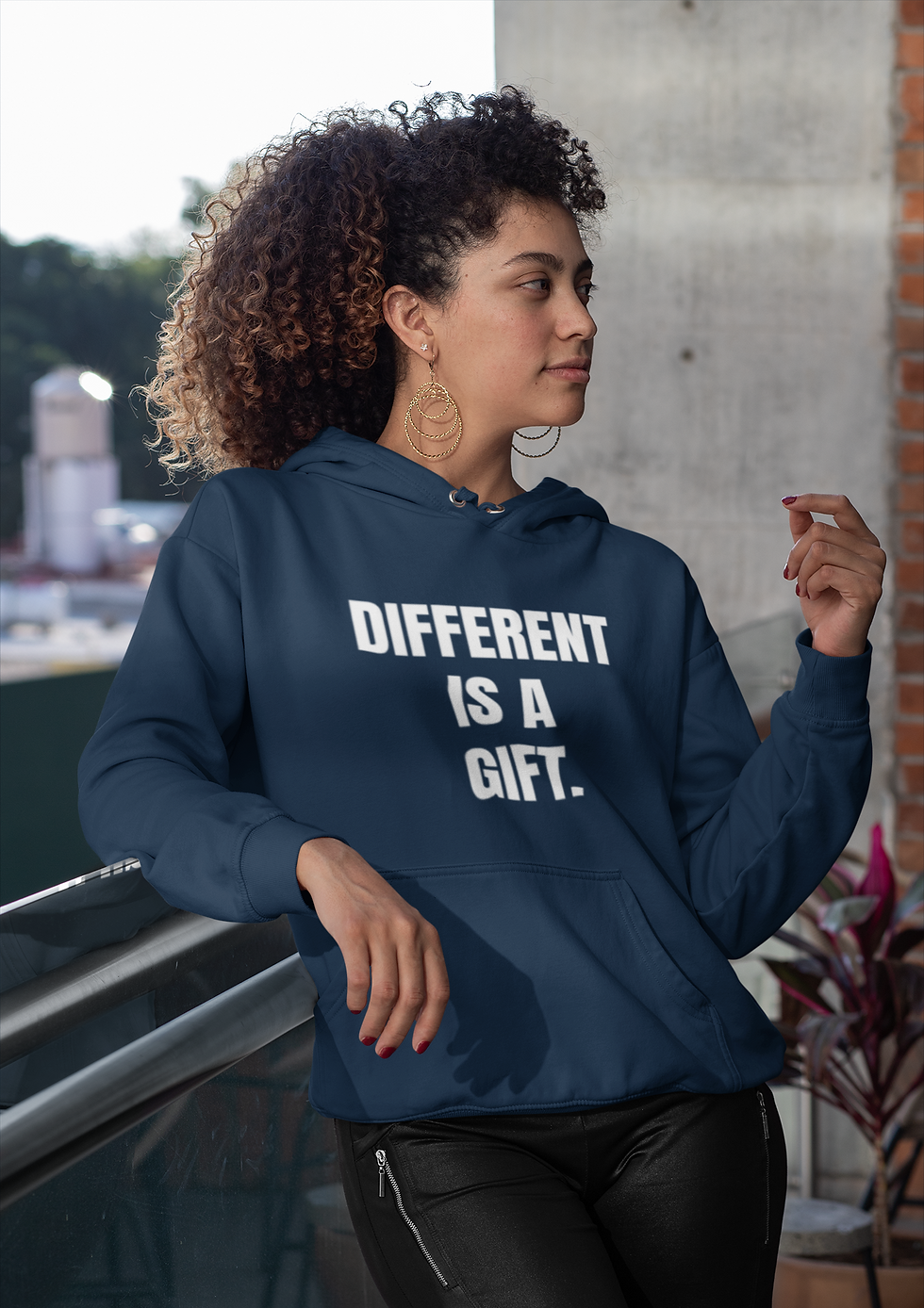 Thumbnail: Woman wearing a Different Is a Gift Classic hoodie with clean stacked lettering.