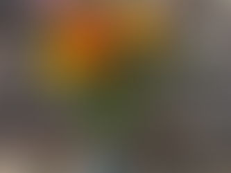 Fresh flowers in orange and yellow colours, in a jam jar vase