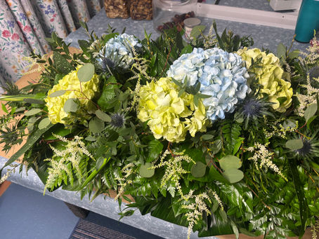 Funeral flowers of mixed brlues and greens