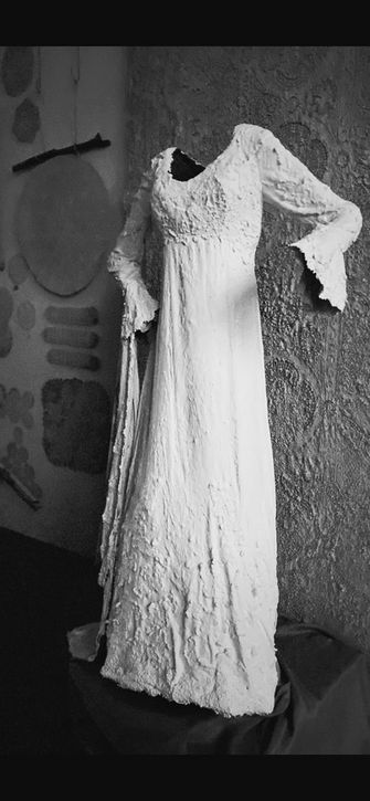 A vintage wedding gown lightly coated in cement.