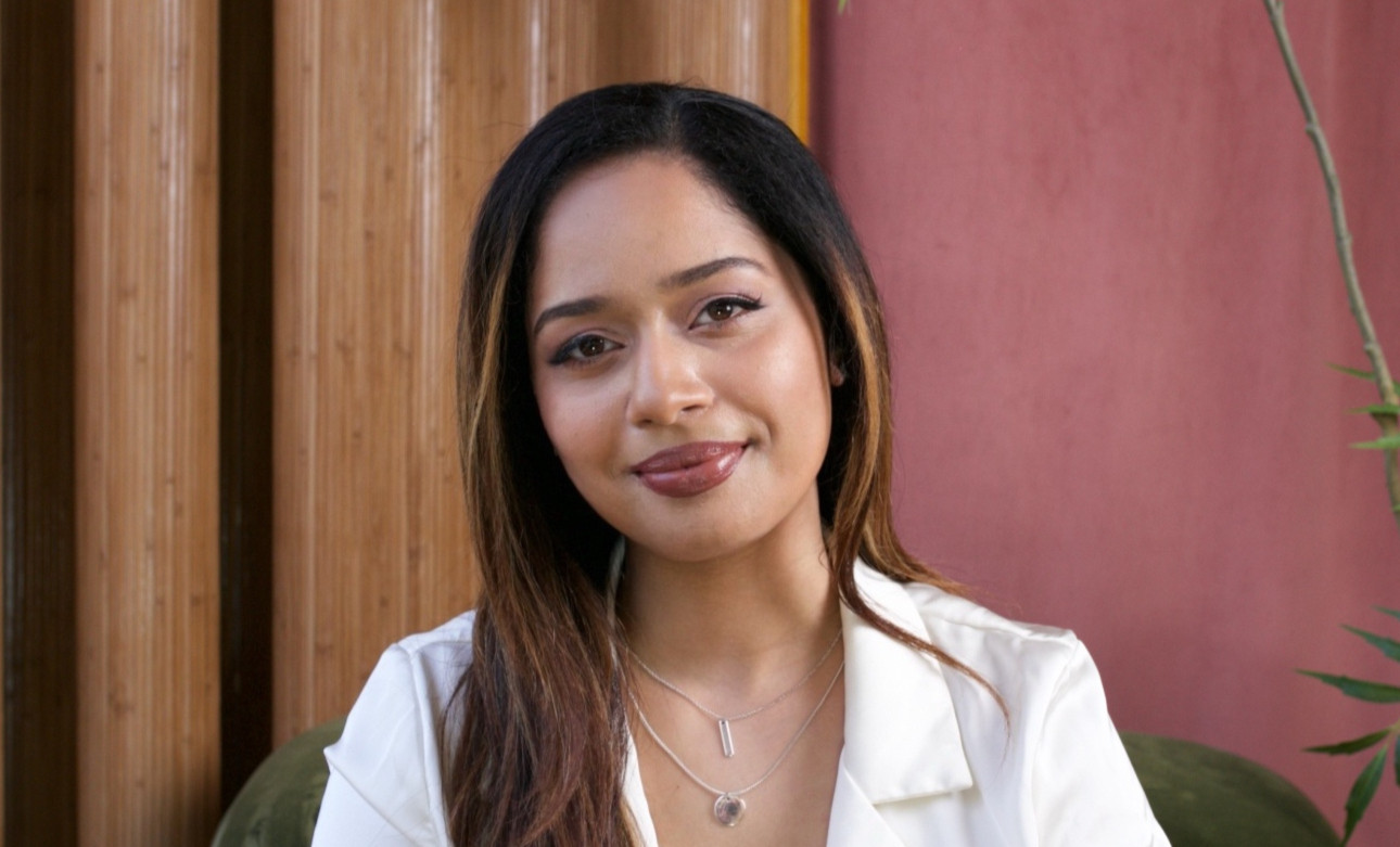 Kiara Vaz, South Asian therapist, smiling gently in a professional portrait, offering support for South Asian adults in NYC | somatic therapy nyc - somatic therapy for south asians nyc - somatic therapy for anxiety nyc