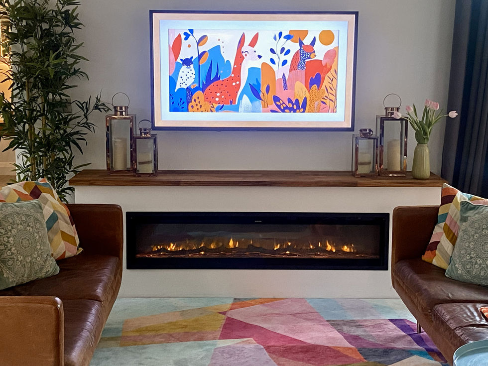 Living room with Frame TV displaying abstract art above electric fireplace.