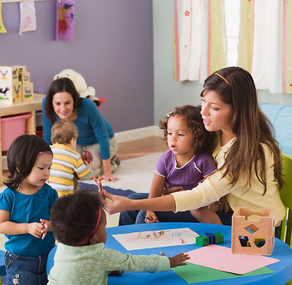 Two teachers with a group of children.