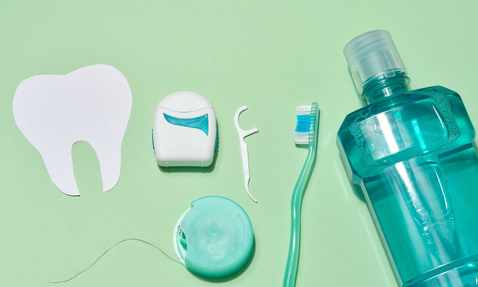 Various dental hygiene products, including a paper tooth cut out, dental floss containers,