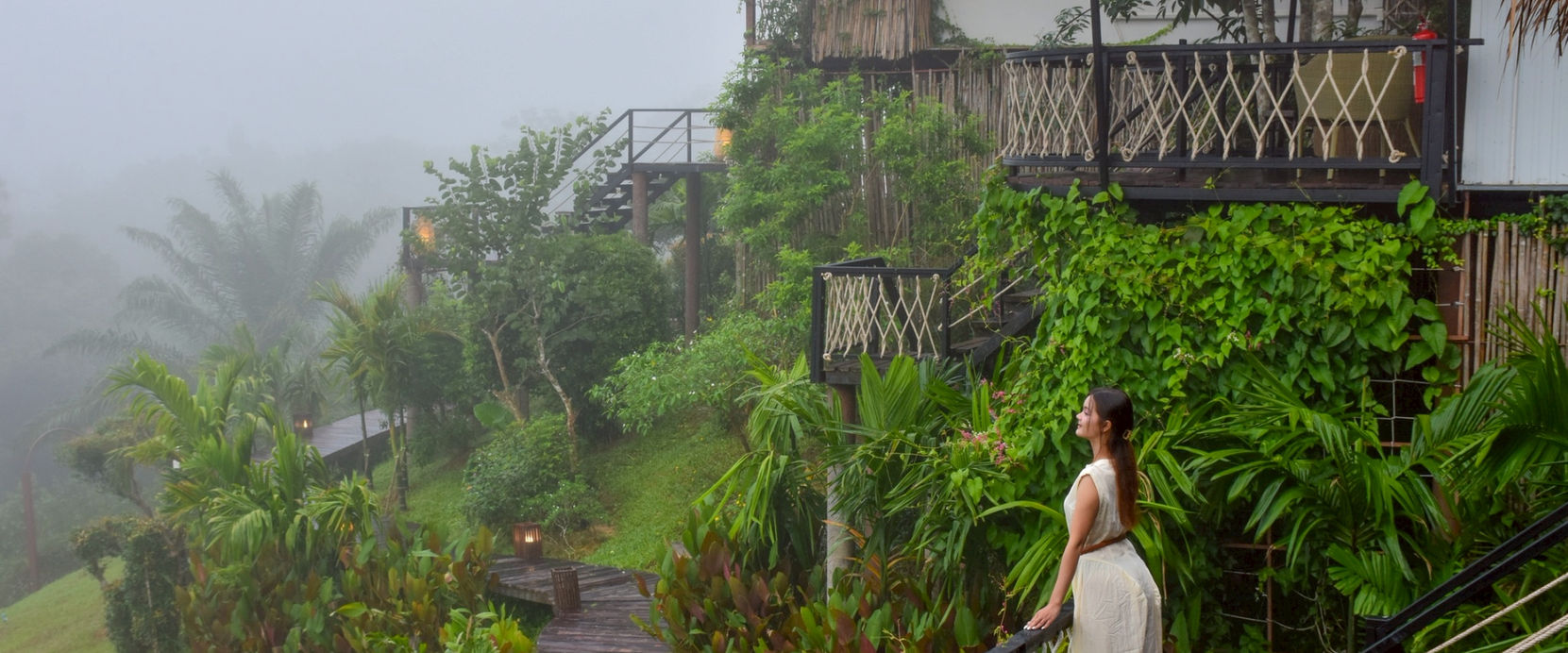 Guest walking through lush gardens toward Exotic Top View villas in Khao Sok