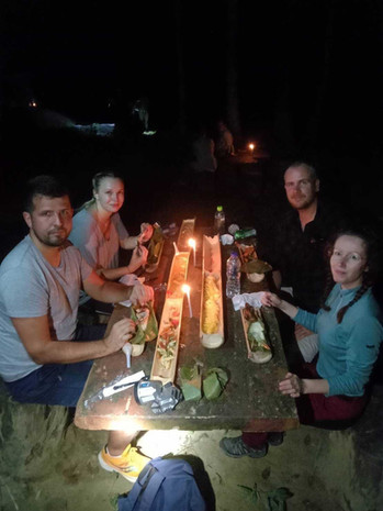Group gathered around a glowing campfire during an overnight Khao Sok adventure
