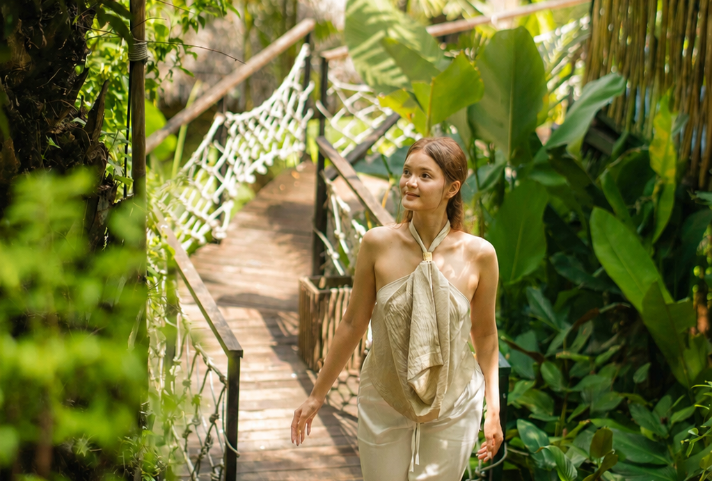 Guest walking along a lush tropical pathway at Khao Sok Boutique Camps