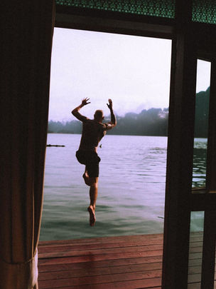 Guest enjoying the morning view from a floating bungalow overlooking Cheow Lan Lake