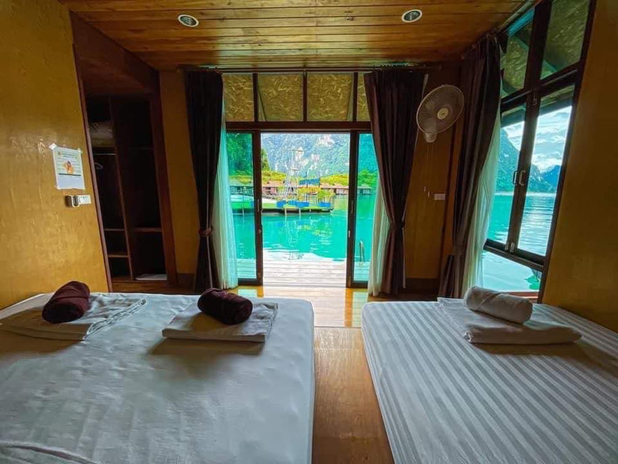 View of Cheow Lan Lake through the doorway of a wooden floating bungalow