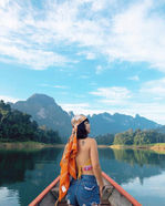 Traveler riding a longtail boat near Klong Ka Raft House on Cheow Lan Lake