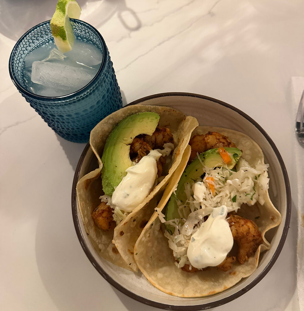 Chili lime grilled shrimp tacos topped with cilantro lime slaw and crema