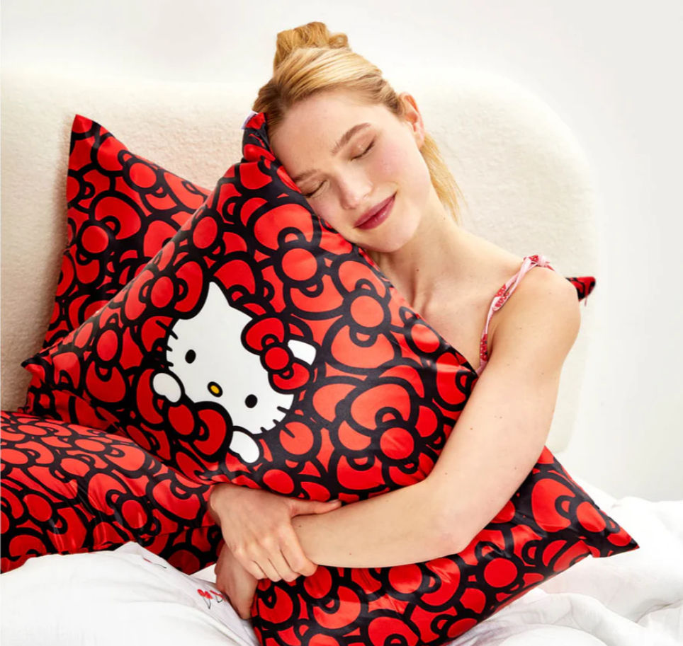 Thumbnail: Kitsch x Hello Kitty Satin Pillowcase in Kitty Bathes in a Sea of Bows