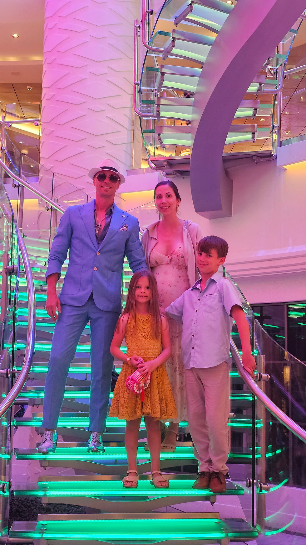 Cruising as a family with kids dressed up family posing for a photo on the cruise ship