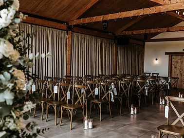 Wedding ceremony setup at Roodles Barn showcasing on-the-day coordination services, featuring a beautifully styled rustic ven