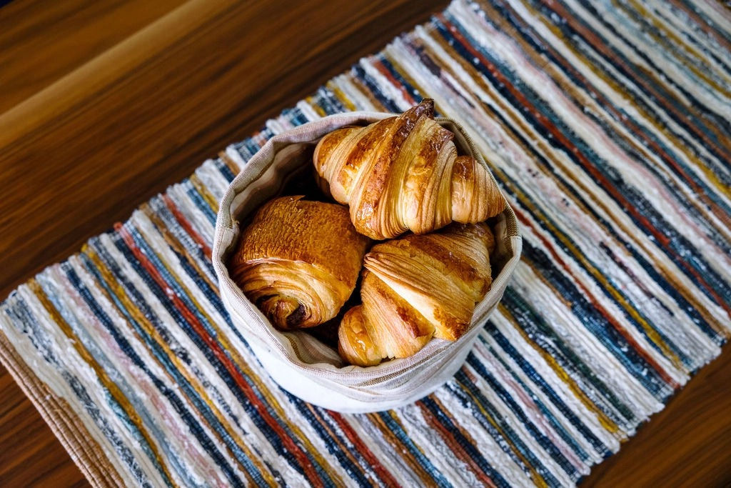 Adesé Handwoven Table Runner on table with pastries