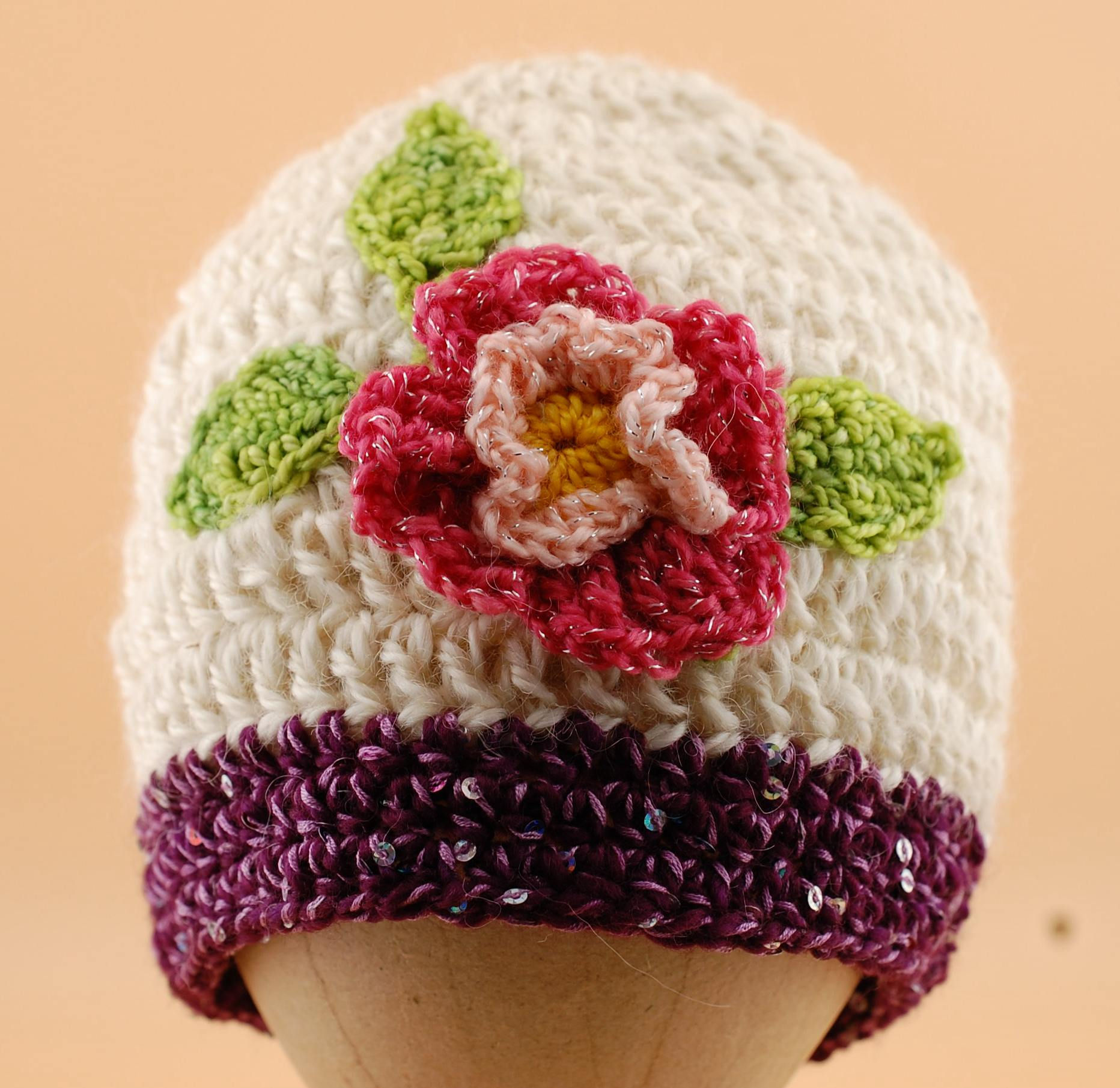 White Crocheted Cloche Style with Deep Pink Trim and Pink Blossom