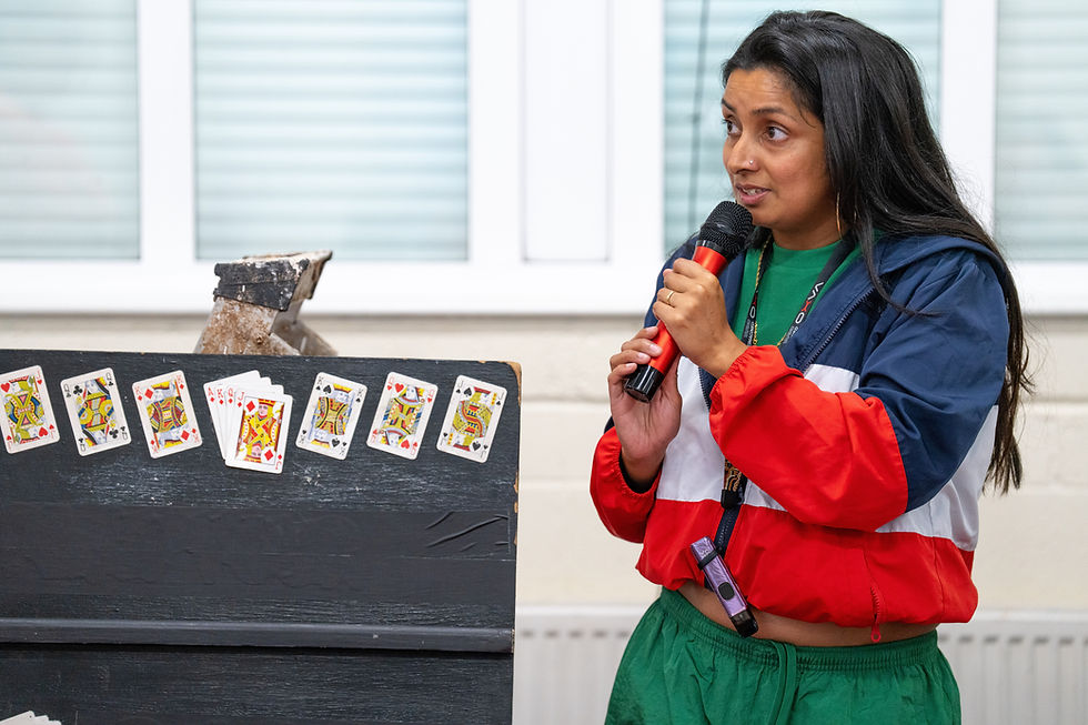 A young South Asian woman in a track suit plays a card game