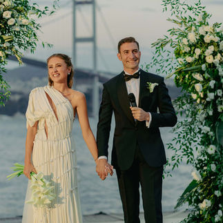 Bride groom smiling at their wedding reception, with the view of Bosphorus behind them.