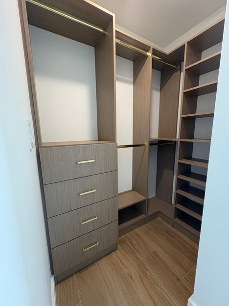 Custom luxury closet with high-end finishes and organized storage solutions by Greatstone Design.