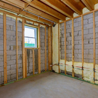 Denver foundation repair contractors evaluating basement foundation walls for damage and moisture issues
