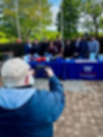 man taking a photo with his phone of a group of veterans