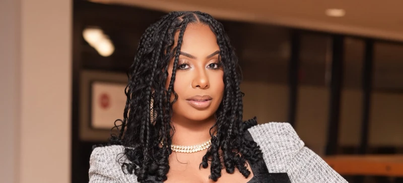 The Travel Advisor posing in a business suit dress.