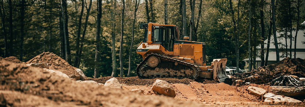 yellow and black heavy equipment on brown soil_edited.jpg
