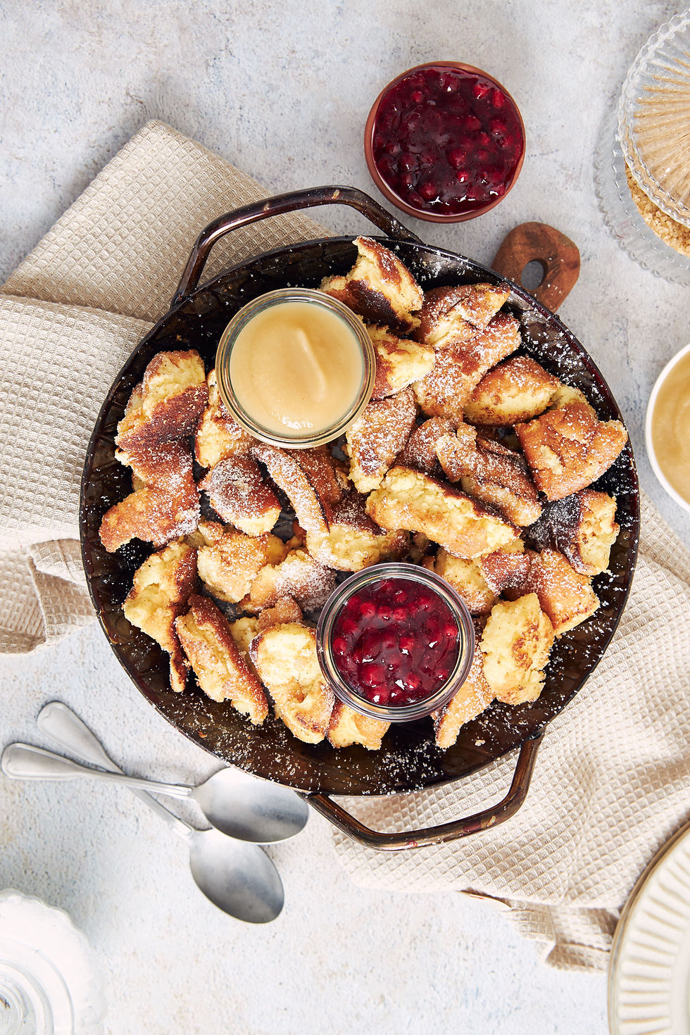 top-view-kaiserschmarrn-with-torn-pancakes-cranberries-jam-apple-puree-table