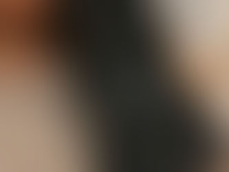 Detail view of glossy, well-conditioned hair draped over a neutral knit sweater, representing smooth winter hair.