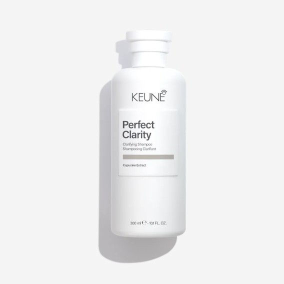 White bottle of Keune Perfect Clarity clarifying shampoo on a light background.