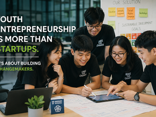 Smiling youths collaborate around a laptop and tablet in a workshop; text reads Youth entrepreneurship is more than startups.