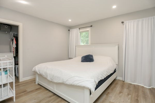 Primary bedroom after renovation with new walk-in closet and ensuite