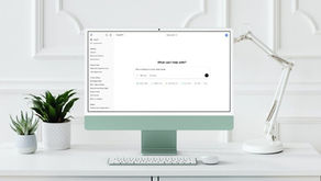 A desktop and lamp on a desk with plants. Screen displays the ChatGPT user interface asking "What can I help with?". representing ChatGPT for small business use in 2025.