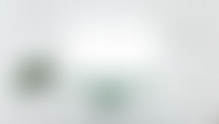 A desktop and lamp on a desk with plants. Screen displays the ChatGPT user interface asking "What can I help with?". representing ChatGPT for small business use in 2025.